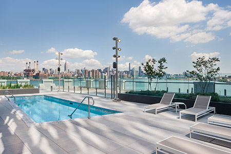 Outside pool with skyline of New York - 1N4 Williamsburg New York